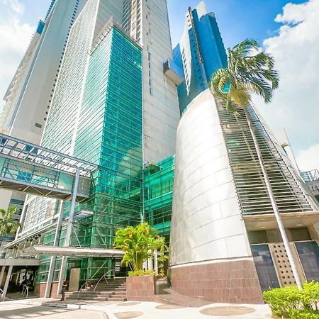 Decapolis Hotel Panama City Exterior photo The photo shows a modern building characterized by its sleek, contemporary architecture. The structure features large glass panels that reflect sunlight, giving it a bright appearance. Part of the building has a curved metallic surface which contrast